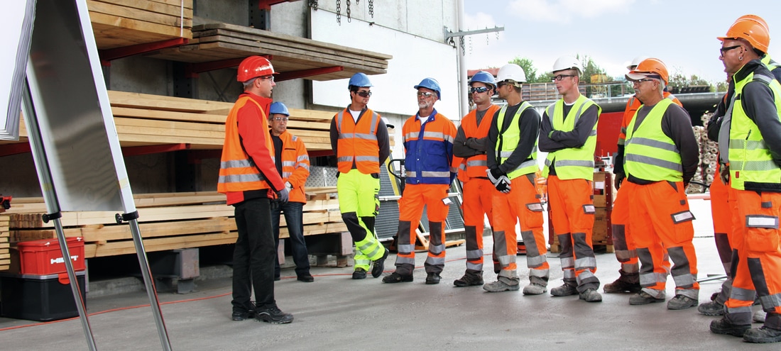 Worker standing together wearing safety gear
