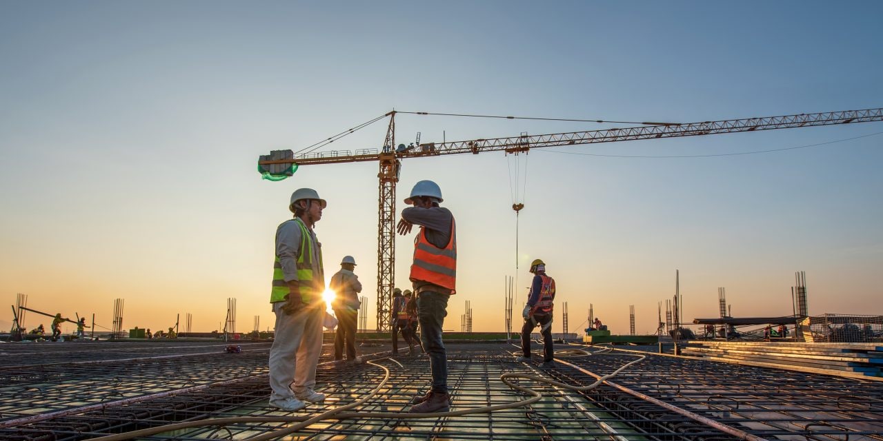 Construction engineer working at construction site during sunset time