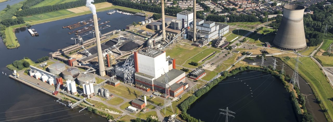 19 July 2016, Geertruidenberg, Holland. Aerial view of the AMERCENTRALE, a coal and biomass fired Essent powerplant. It's located at the river Amer. In the back the town of GEERTRUIDENBERG. 