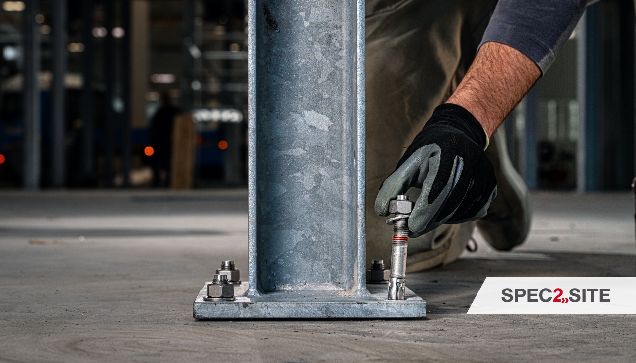 A contractor installs an anchor into a baseplate